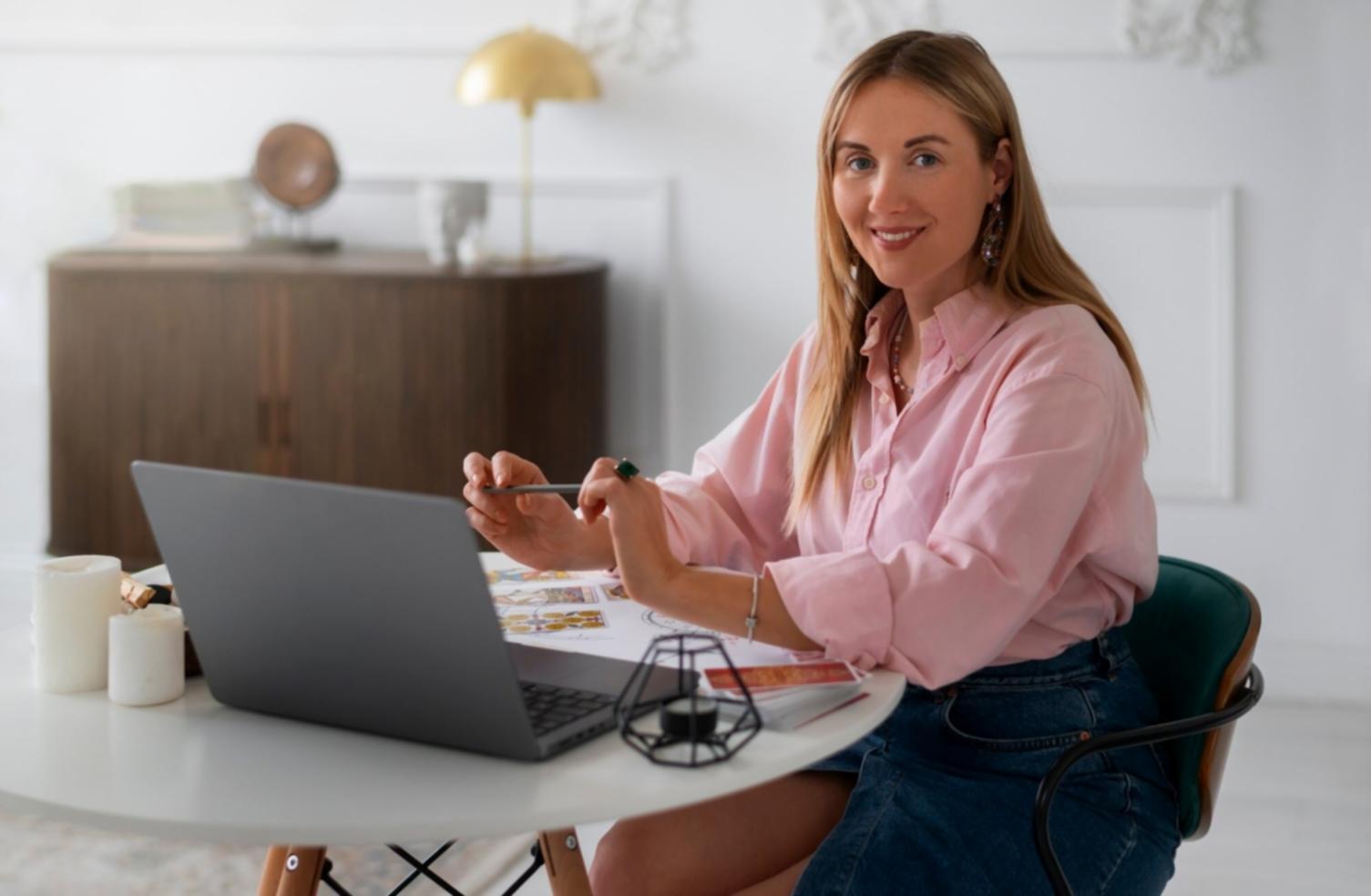 Person reviewing financial documents with calculator and laptop